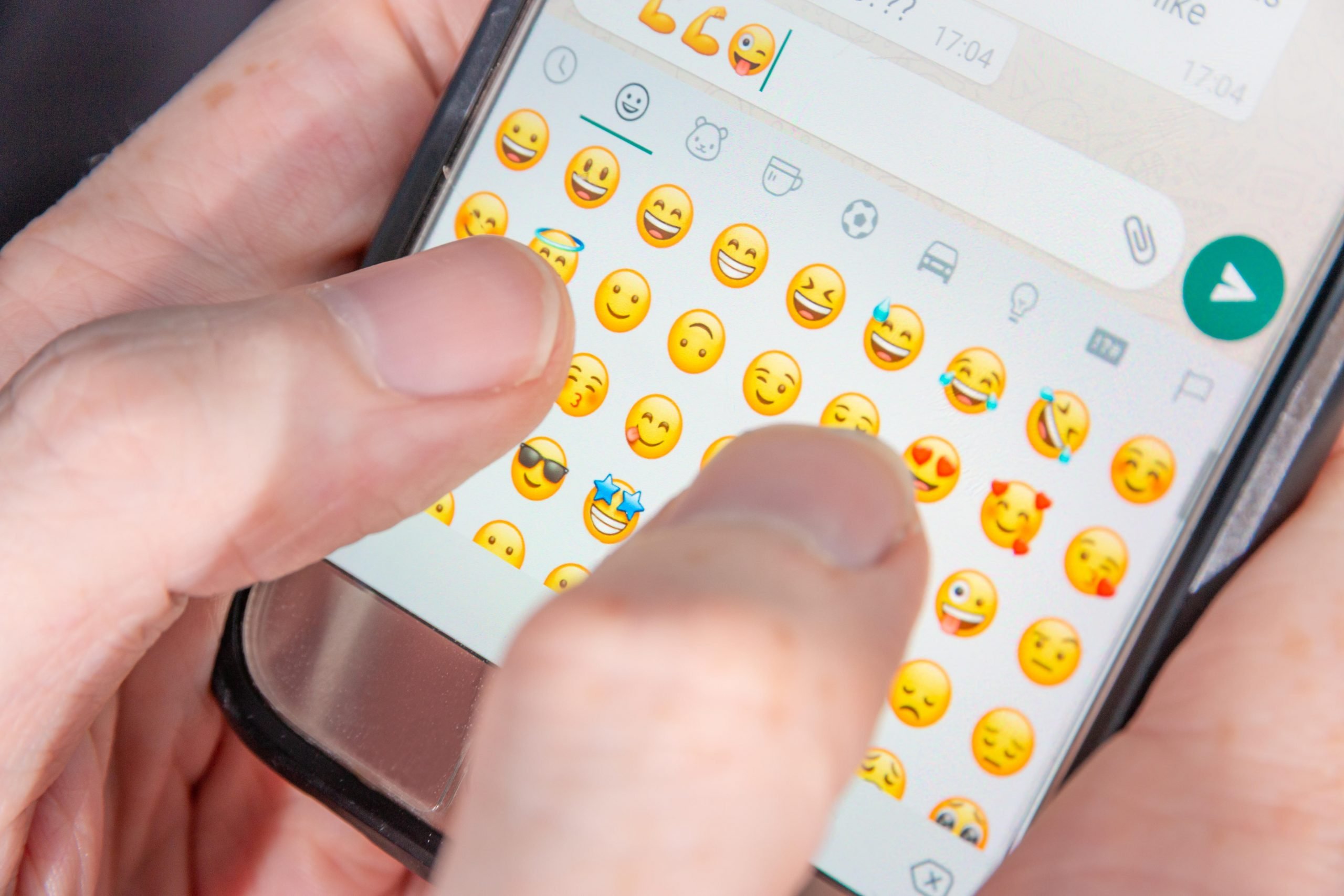 Person using emojis in text. 