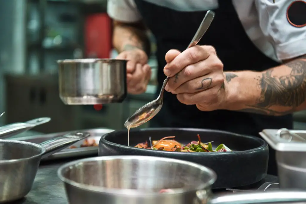 Chef preparing dish. 