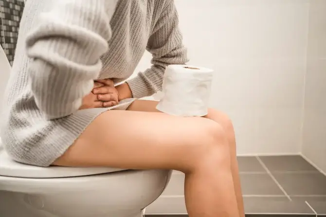Woman on the toilet.