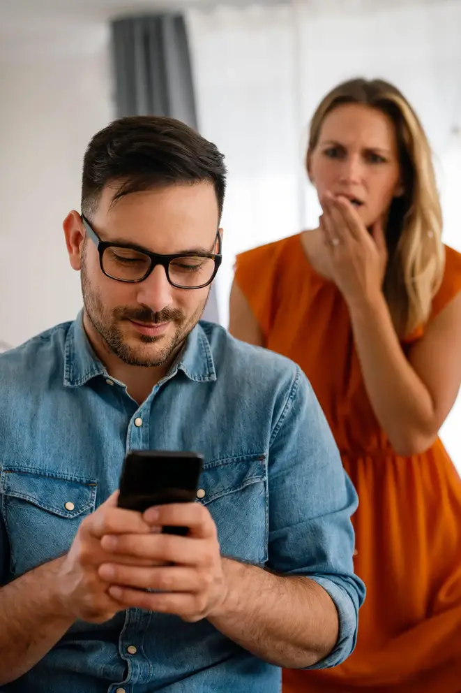 Woman watching partner on phone.