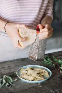 Person grating cheese.