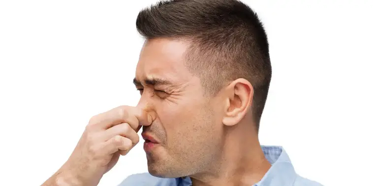 Man holding nose