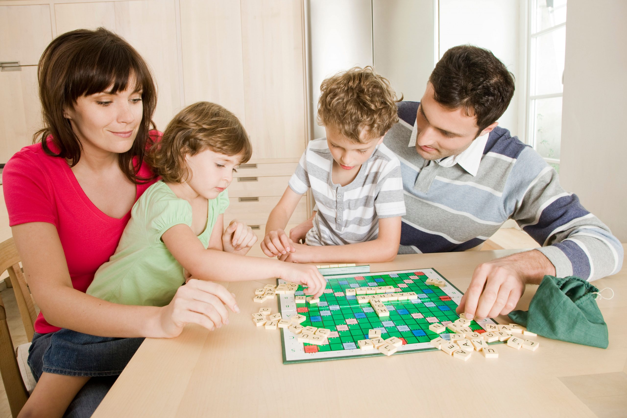 Family playing Scrabble.
