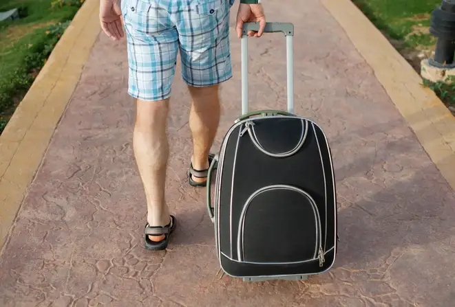 Man walking with suitcase.