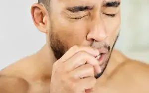 Man removing nose hair.