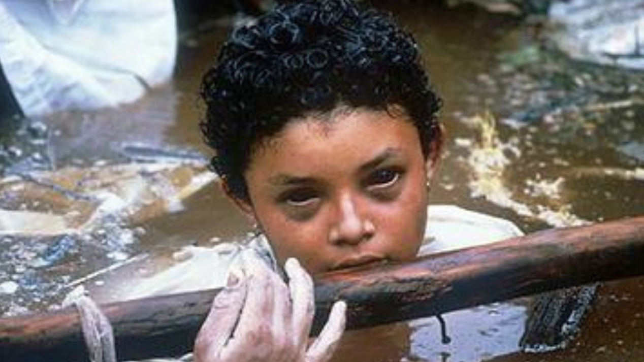 A photographer captured a harrowing image of a young girl trapped after a volcanic disaster but did not try to help her.