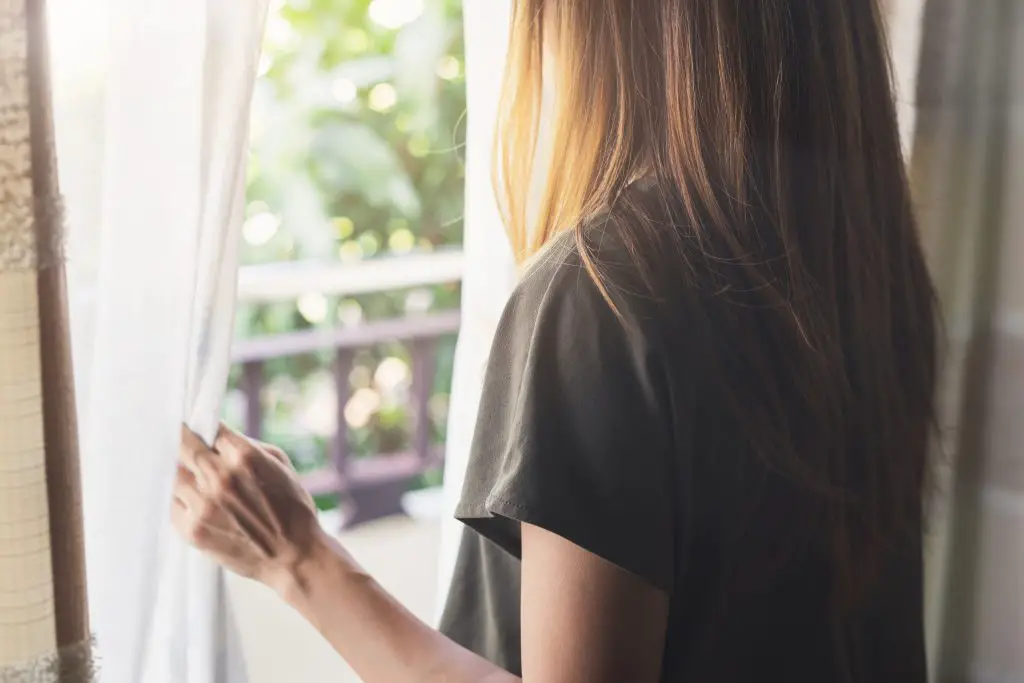 Woman looking out of window.