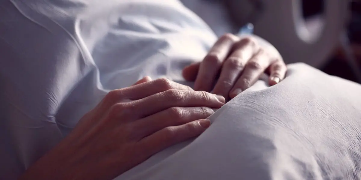 Woman in hospital bed.