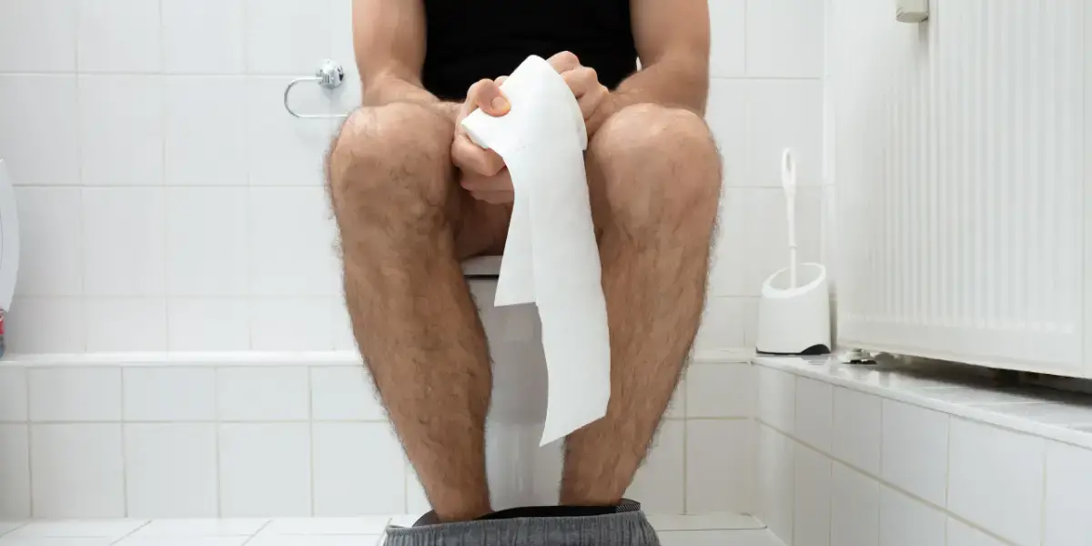 Man sitting on the toilet. 