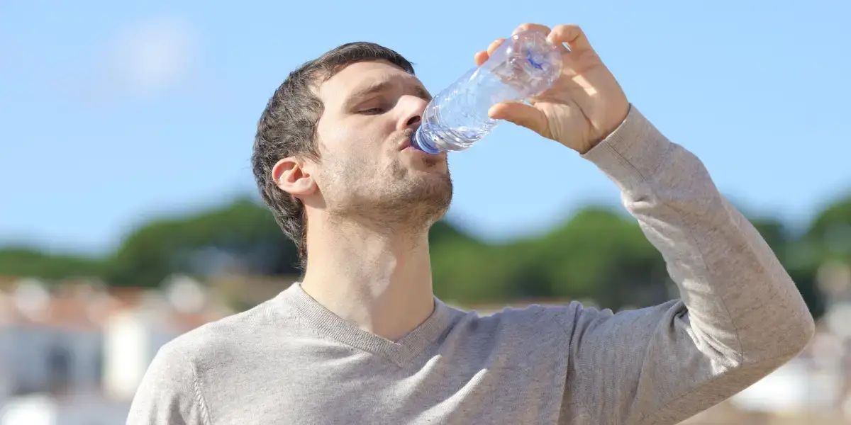 Man drinking bottled water. 