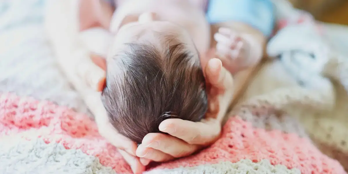 Woman holding a baby. 