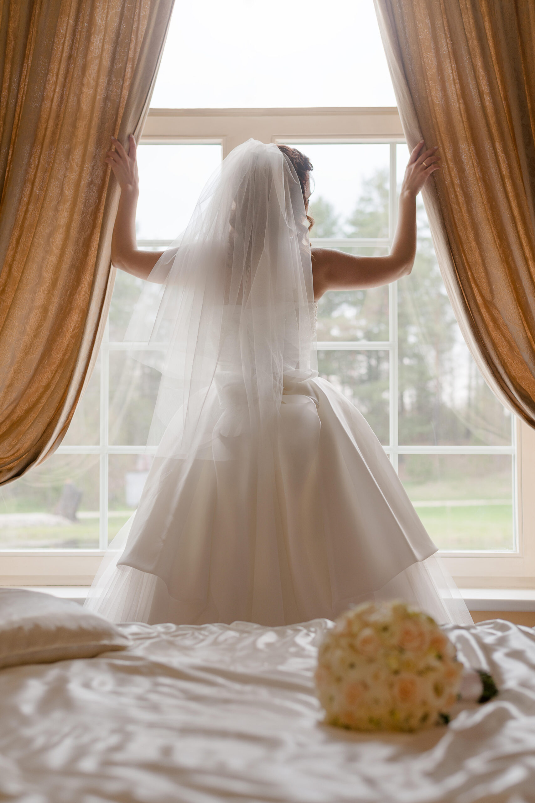 Bride looking out of window. 