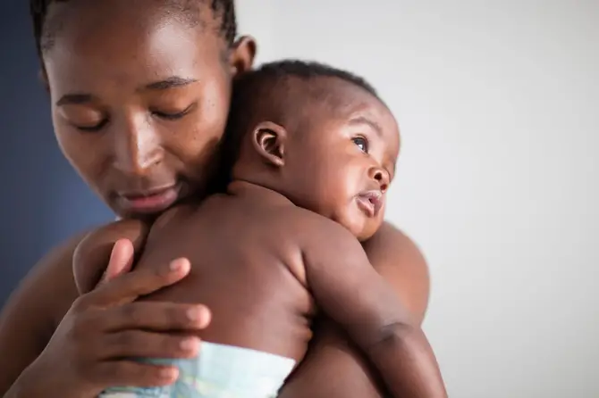 Woman holding baby.