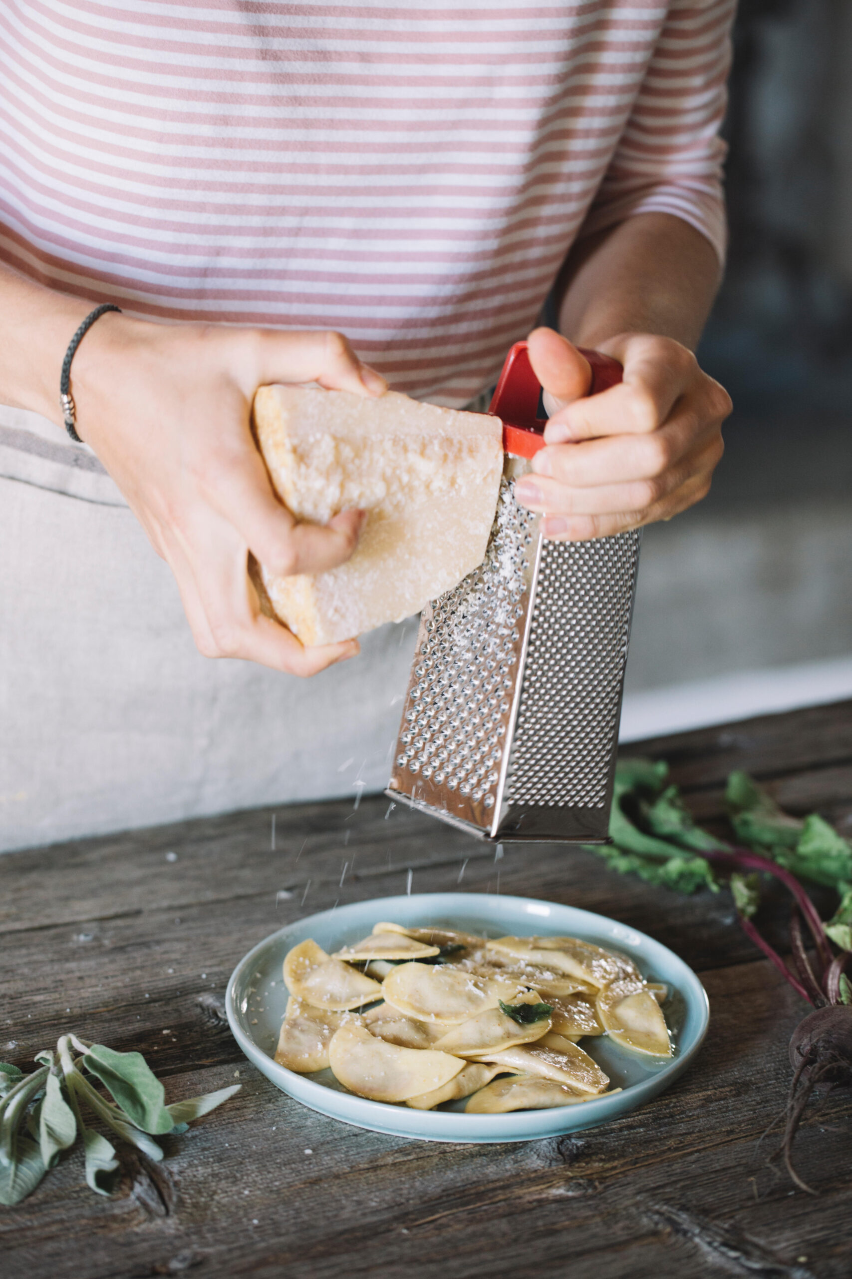 Woman grating cheese.