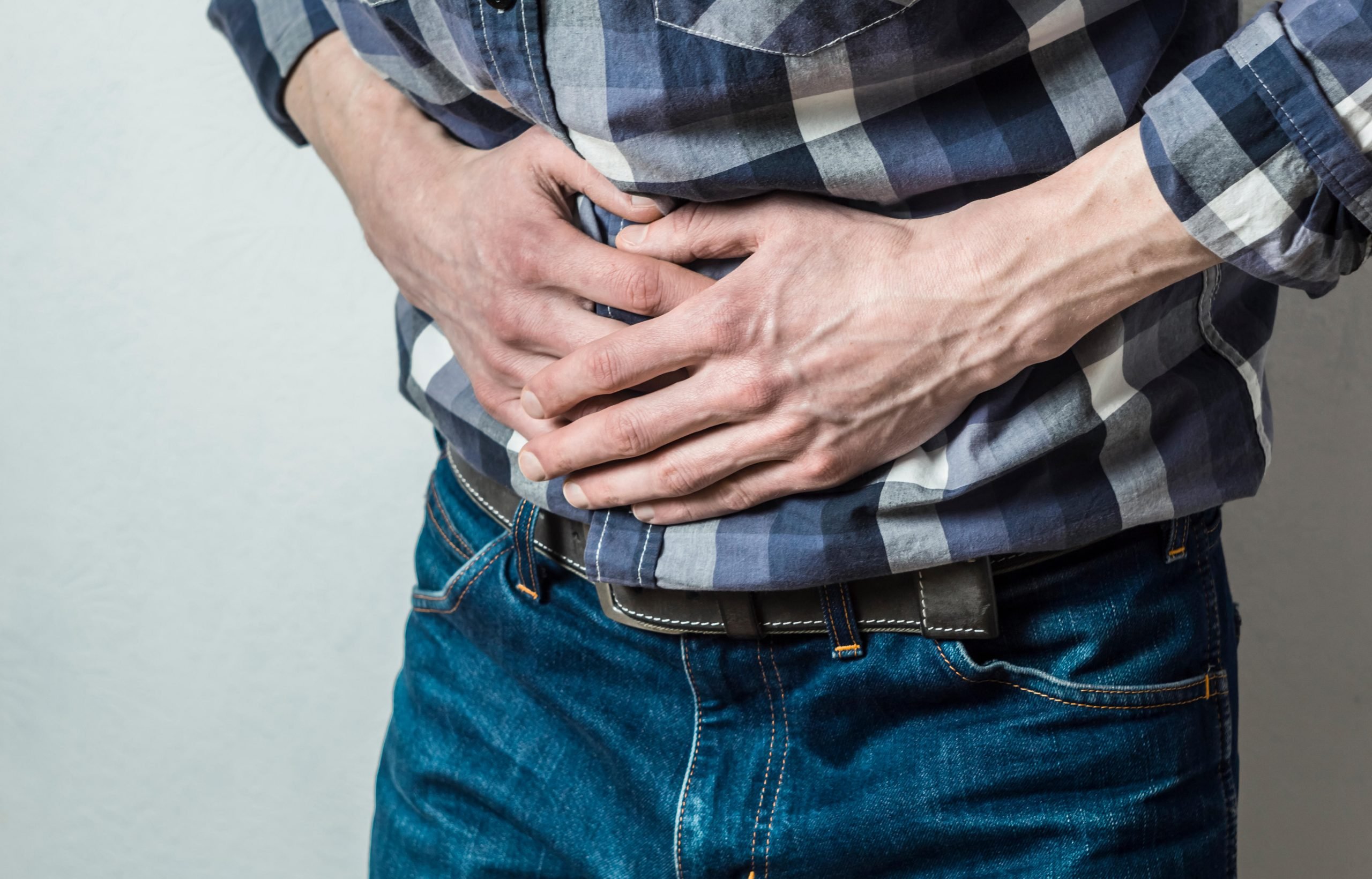 Man holding stomach in pain. 