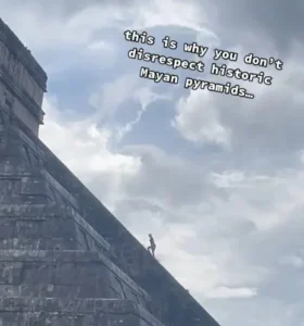 Woman climbs ancient pyramid. 