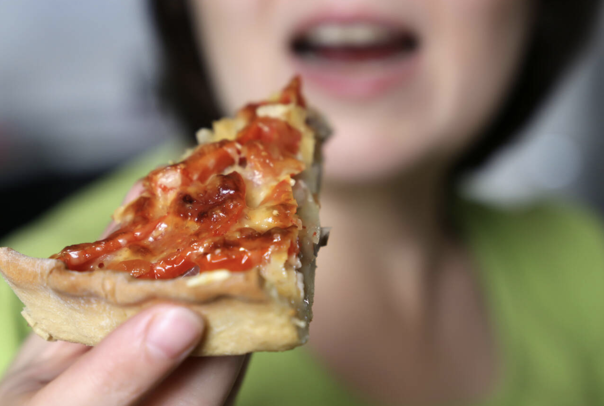 Woman eating pizza