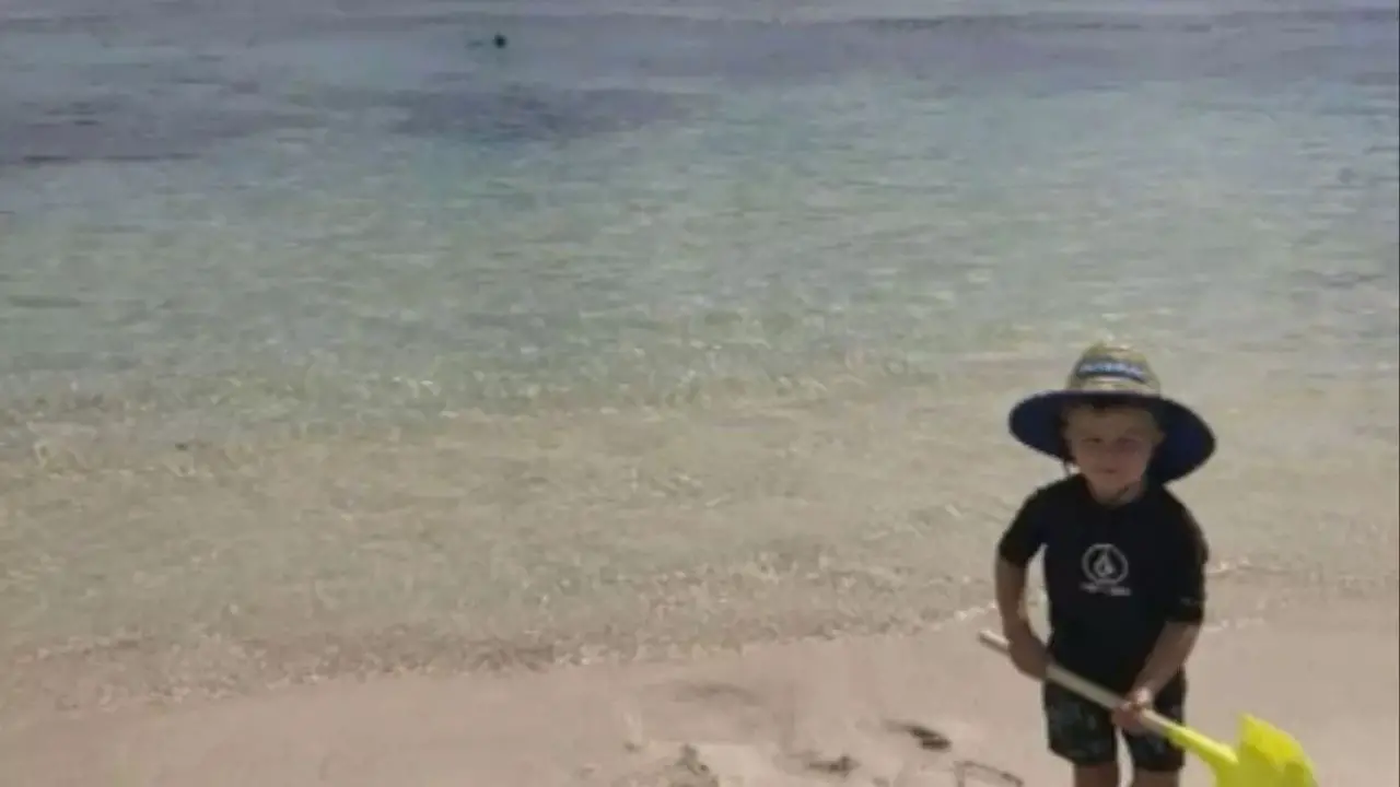 A haunting photo of a dad with his son at the beach was taken in the final moments before he died.