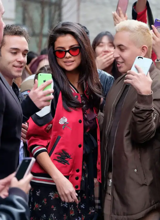 Selena Gomez in red-tinted glasses.