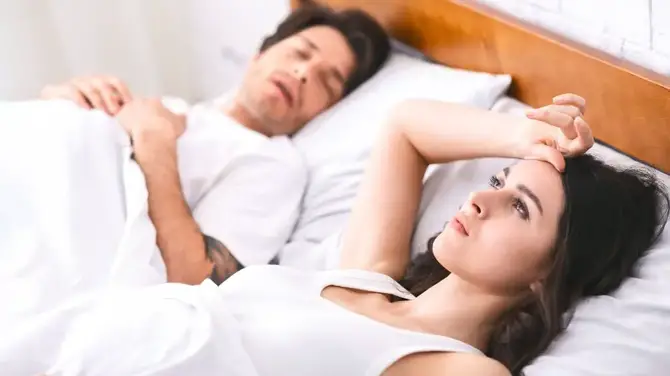 Man and woman in bed.