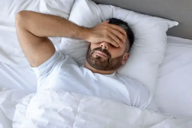 Man struggling to sleep.