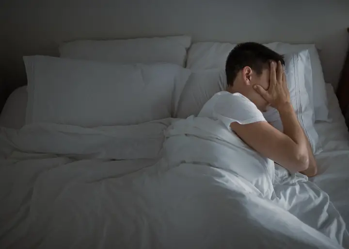 Stressed man in bed.