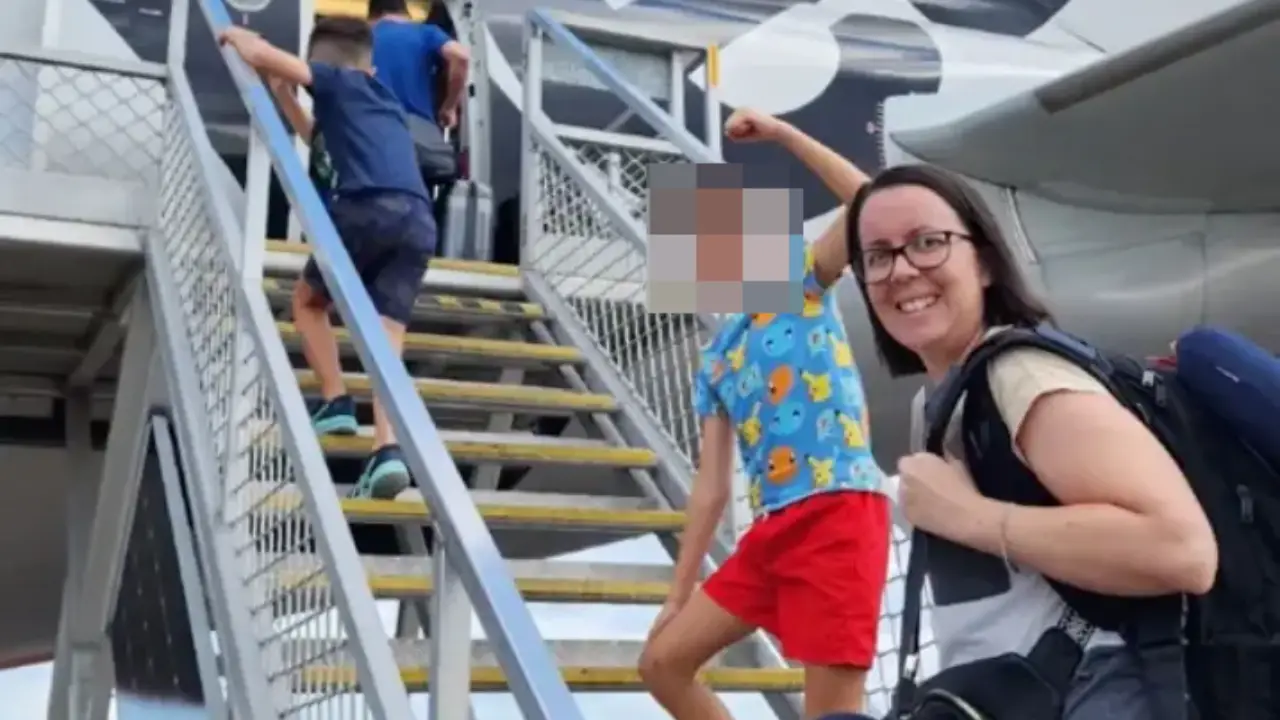 A dad claims that an innocent photo he took of his family boarding a plane resulting in them being kicked off the flight.