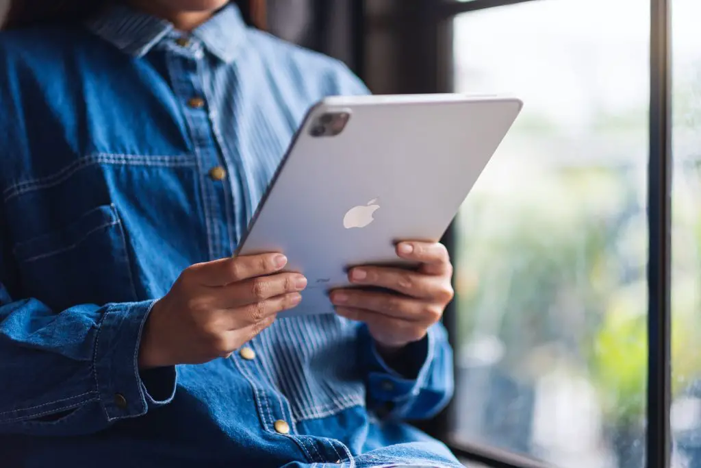 Person holding iPad.
