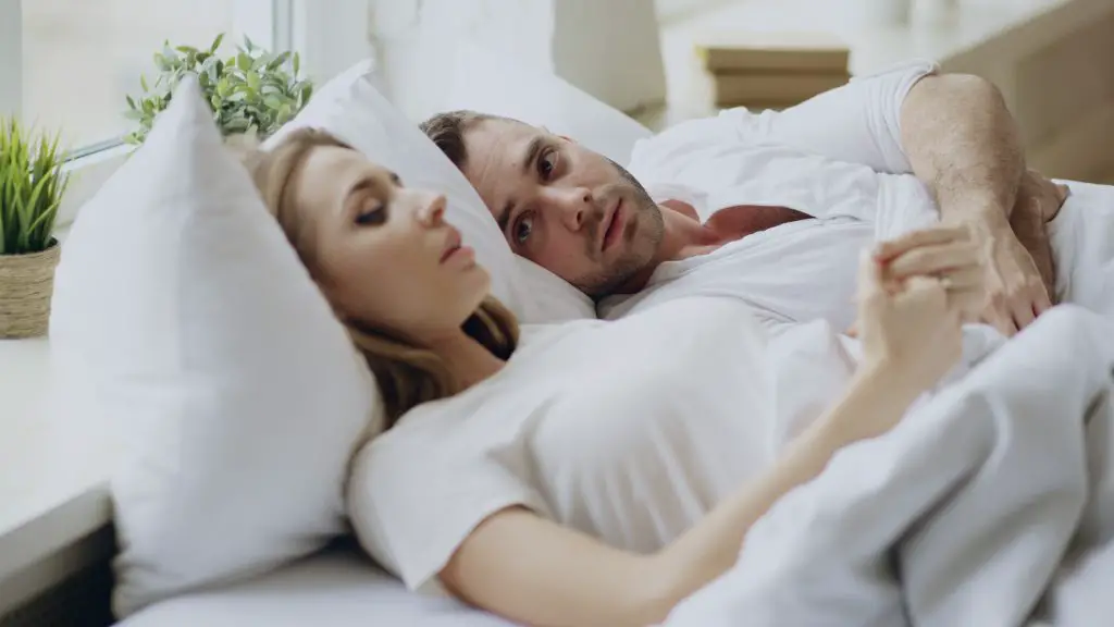 Stressed couple in bed.