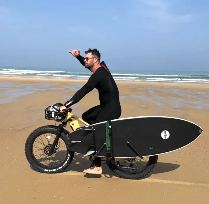 Chris Hemsworth on a beach.