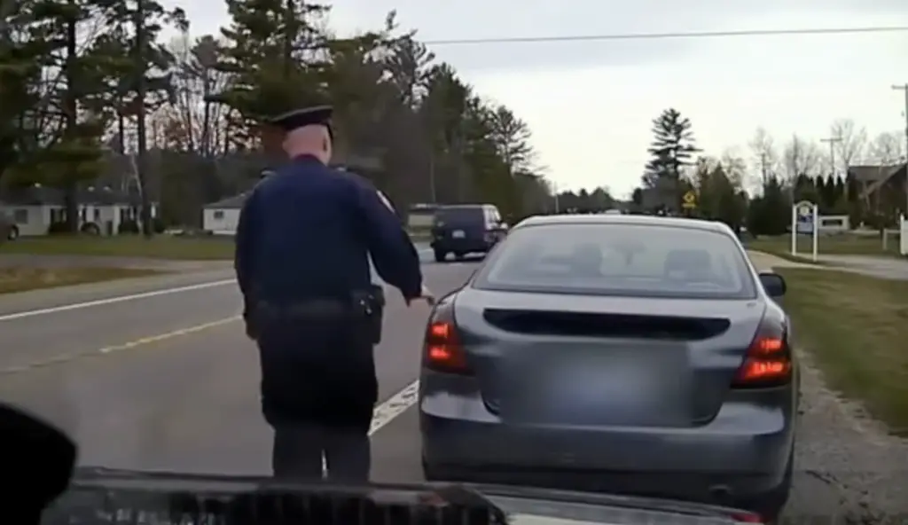 Cop touching tail light