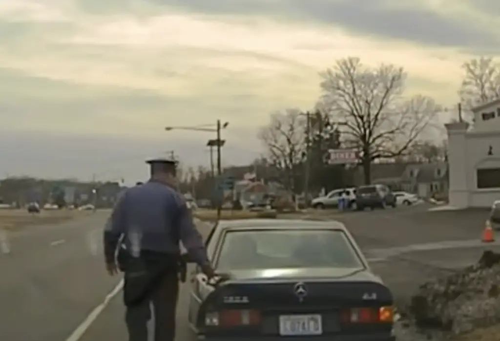 Cop touching tail light